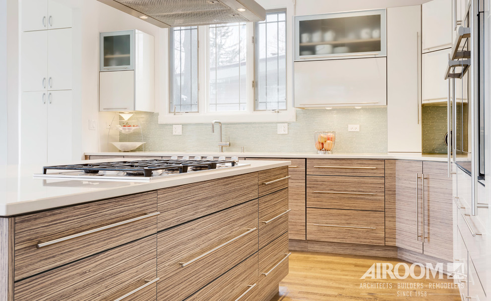 Modern kitchen in Chicago with flat-panel cabinets, white cabinets, engineered stone countertops and an island.