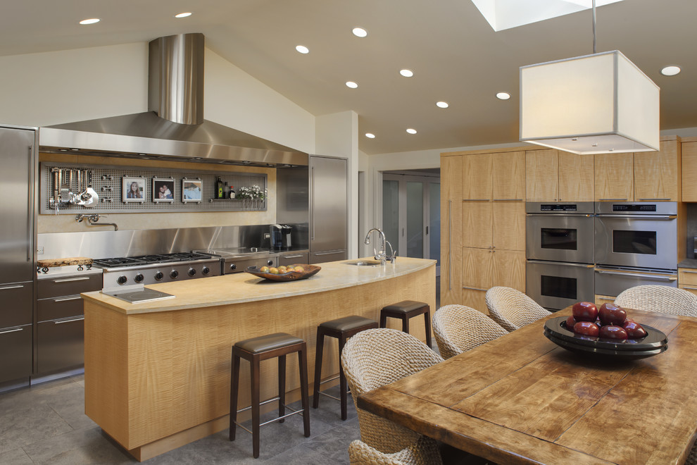 This is an example of a contemporary kitchen/diner in Chicago with stainless steel appliances.