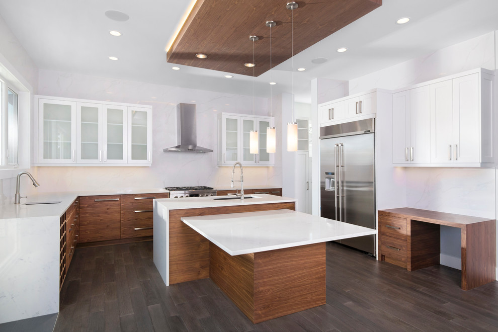 Inspiration for a large contemporary u-shaped kitchen/diner in Calgary with a submerged sink, shaker cabinets, medium wood cabinets, engineered stone countertops, white splashback, ceramic splashback, stainless steel appliances, dark hardwood flooring and an island.