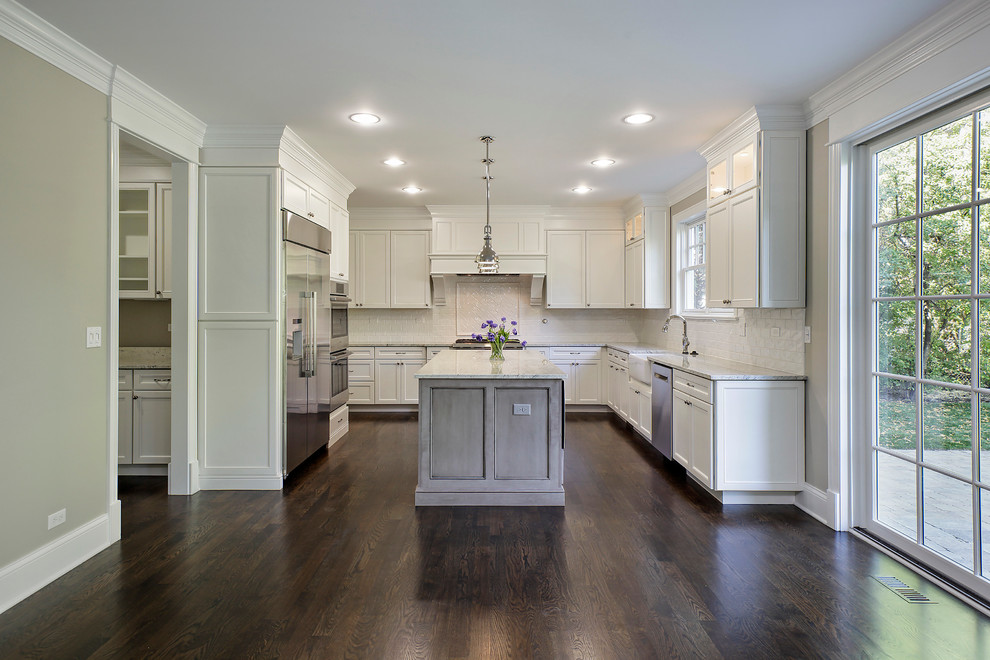 Example of a large transitional u-shaped dark wood floor eat-in kitchen design in Chicago with a farmhouse sink, shaker cabinets, white cabinets, granite countertops, white backsplash, ceramic backsplash, stainless steel appliances and an island