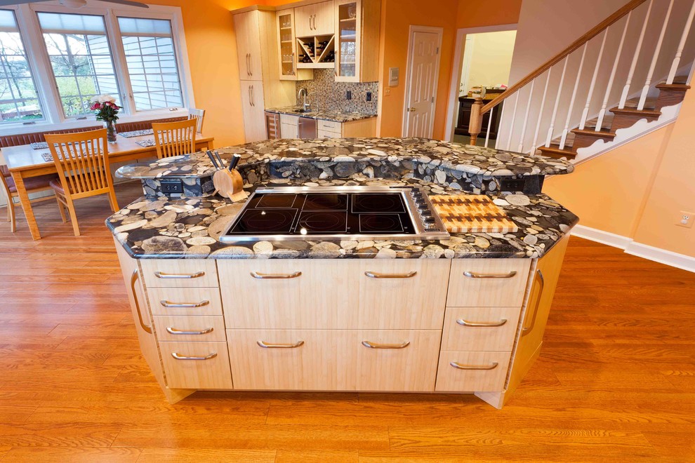 Mid-sized transitional l-shaped bamboo floor eat-in kitchen photo in Baltimore with an undermount sink, flat-panel cabinets, light wood cabinets, granite countertops, multicolored backsplash, glass tile backsplash, stainless steel appliances and an island