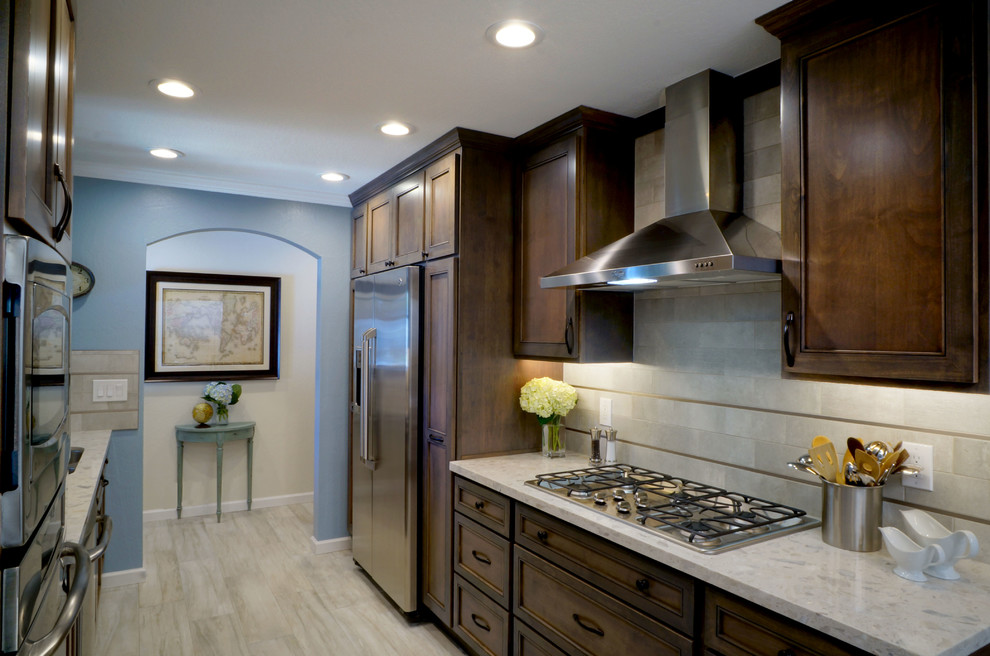 Example of a small transitional galley porcelain tile eat-in kitchen design in San Francisco with an undermount sink, recessed-panel cabinets, medium tone wood cabinets, quartz countertops, gray backsplash, stone tile backsplash, stainless steel appliances and a peninsula