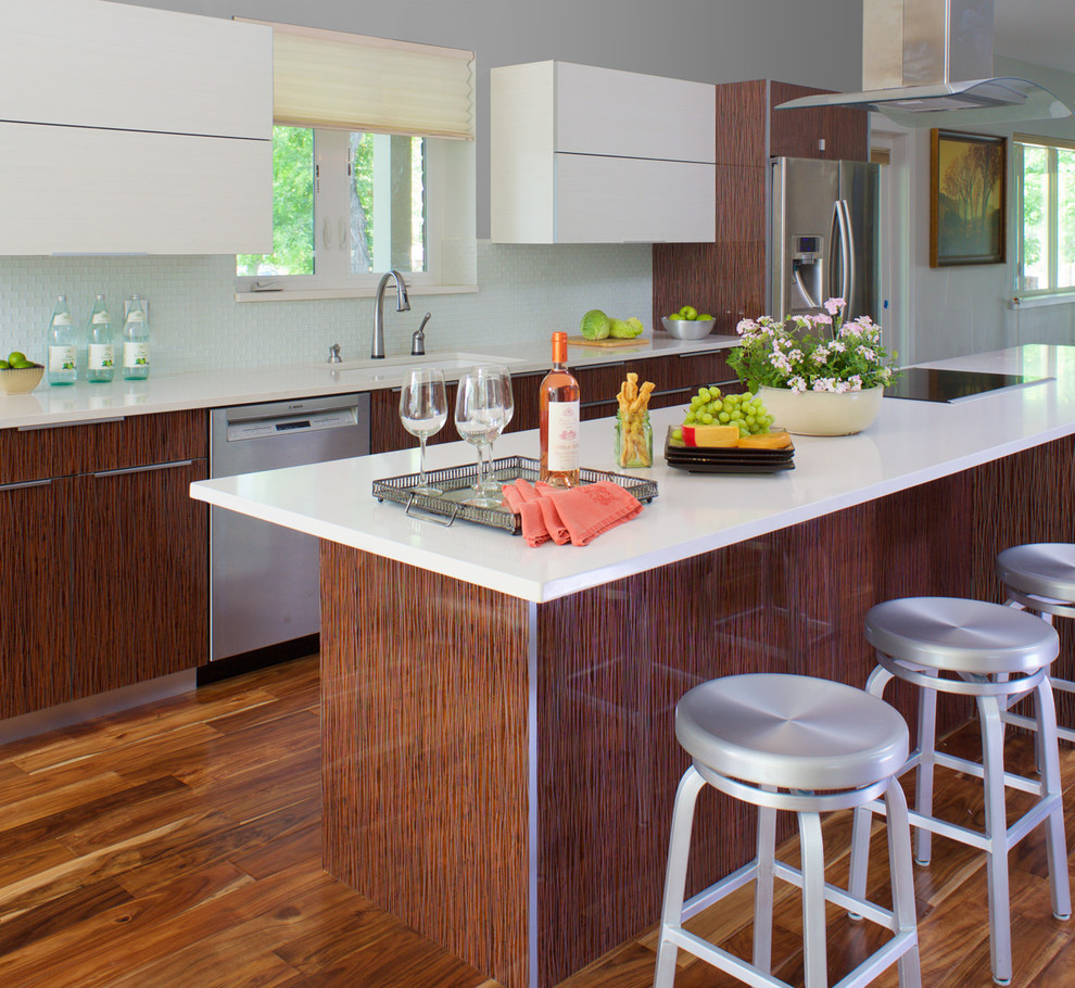 Design ideas for a traditional kitchen in Denver with a built-in sink, brown cabinets, blue splashback, glass tiled splashback, stainless steel appliances, medium hardwood flooring and an island.