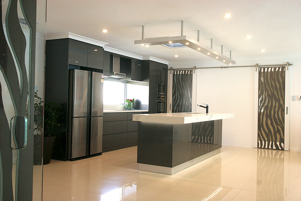 Inspiration for a large modern galley open plan kitchen in Perth with a double-bowl sink, flat-panel cabinets, black cabinets, marble worktops, black splashback, glass sheet splashback, stainless steel appliances, porcelain flooring, an island, white floors and white worktops.