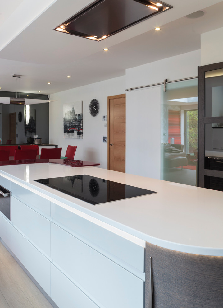 Design ideas for a large modern l-shaped kitchen/diner in Other with a double-bowl sink, flat-panel cabinets, white cabinets, laminate countertops, grey splashback, glass sheet splashback and an island.