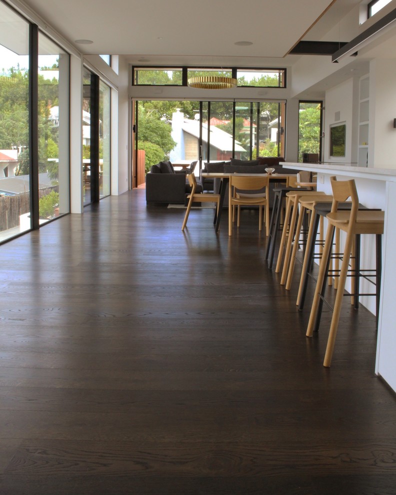 Inspiration for a modern kitchen in Auckland with light hardwood flooring and brown floors.