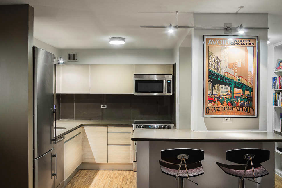 Photo of a contemporary grey and cream kitchen in Chicago with stainless steel appliances.