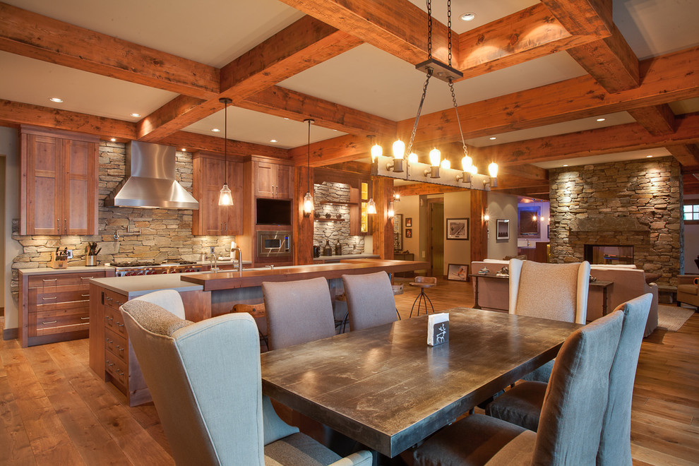 Inspiration for a large rustic l-shaped medium tone wood floor eat-in kitchen remodel in Vancouver with shaker cabinets, light wood cabinets, wood countertops, stone tile backsplash, stainless steel appliances and an island
