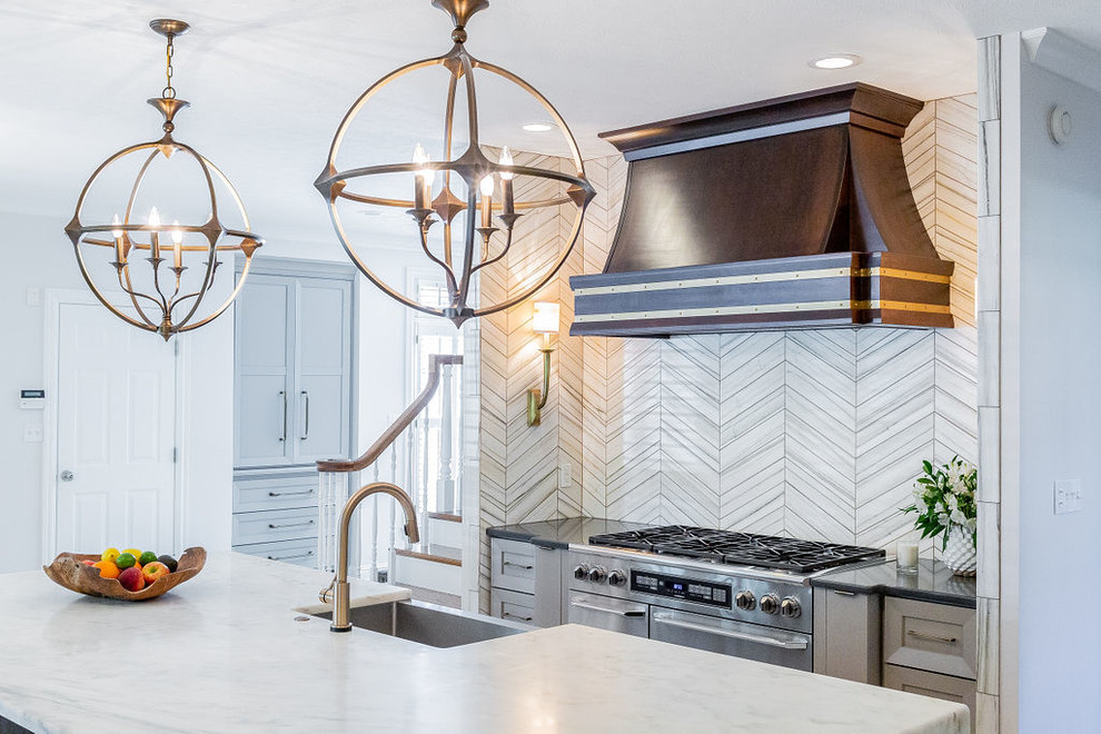 Example of a large minimalist u-shaped porcelain tile and gray floor kitchen design in Other with a farmhouse sink, gray cabinets, marble countertops, gray backsplash, marble backsplash, stainless steel appliances, an island and multicolored countertops