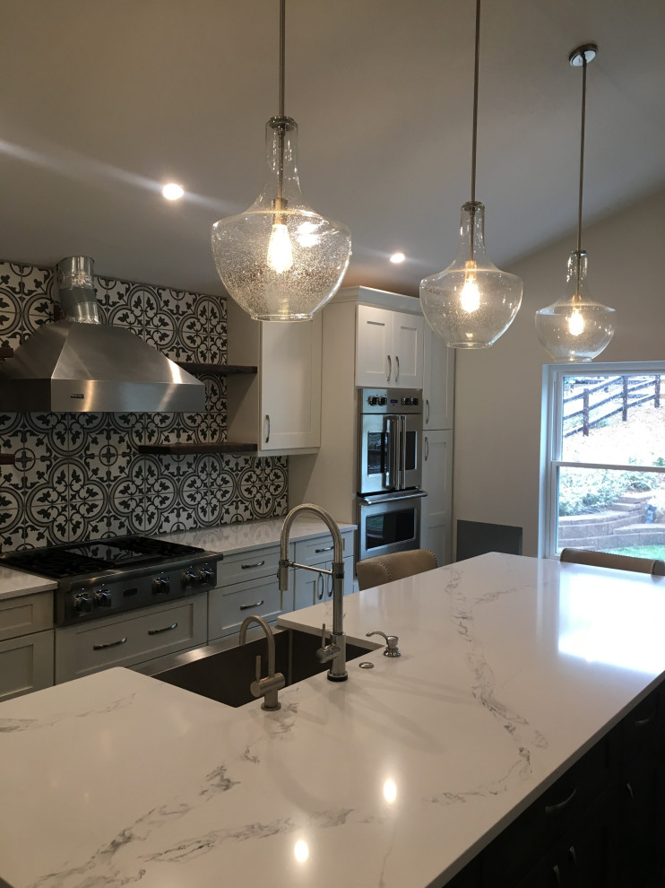 This is an example of a medium sized farmhouse open plan kitchen in Denver with a belfast sink, shaker cabinets, grey cabinets, quartz worktops, multi-coloured splashback, cement tile splashback, stainless steel appliances, dark hardwood flooring, an island, grey floors and white worktops.