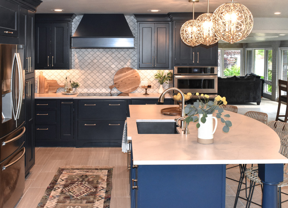 Large transitional l-shaped porcelain tile and beige floor eat-in kitchen photo in Seattle with an undermount sink, beaded inset cabinets, blue cabinets, quartz countertops, white backsplash, marble backsplash, stainless steel appliances, an island and white countertops