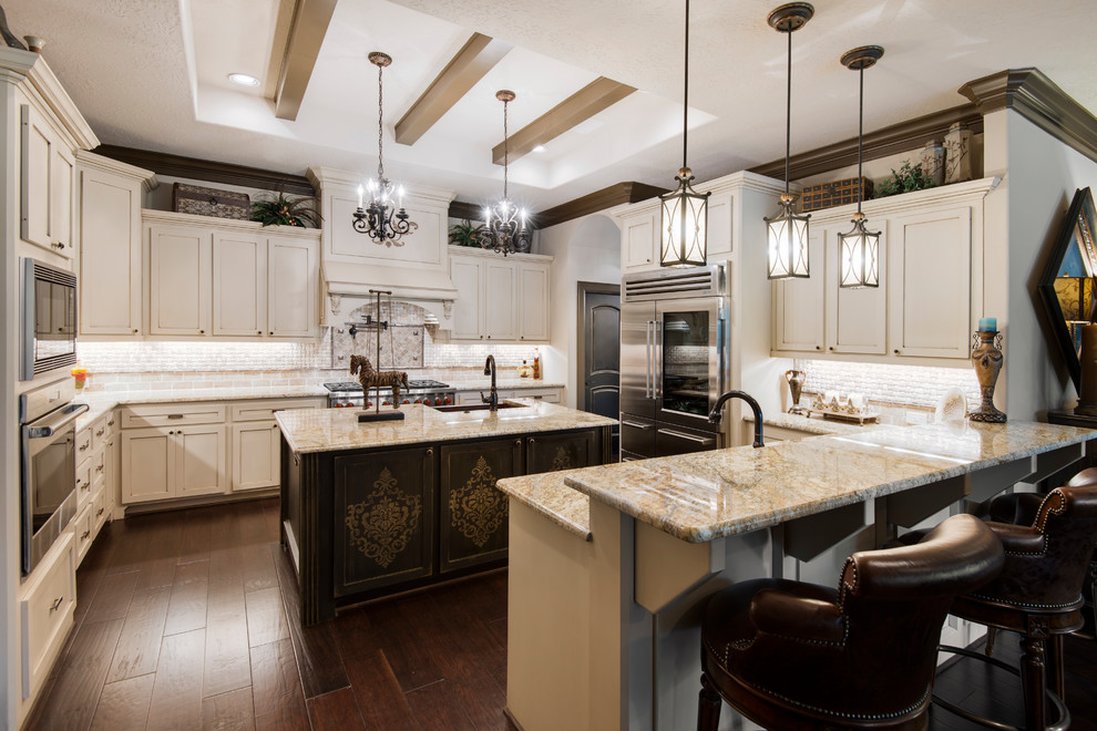 Elegant u-shaped dark wood floor and brown floor kitchen photo in Houston with shaker cabinets, white cabinets, stainless steel appliances, no island and beige countertops