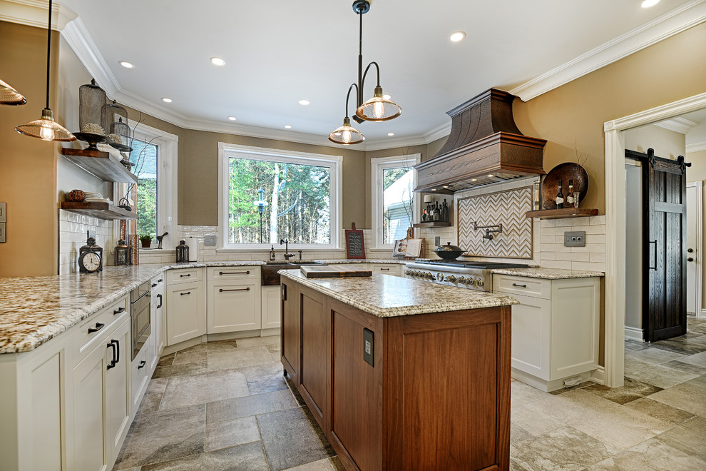 Large elegant u-shaped ceramic tile enclosed kitchen photo in Ottawa with a farmhouse sink, raised-panel cabinets, white cabinets, granite countertops, white backsplash, ceramic backsplash, stainless steel appliances and an island