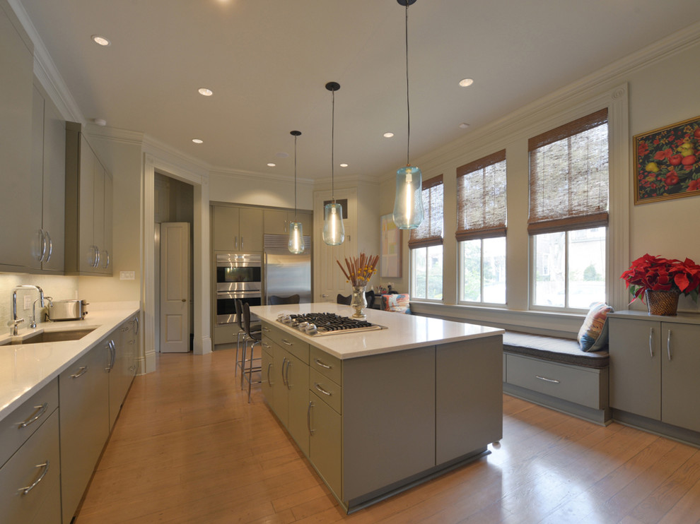Large trendy single-wall light wood floor enclosed kitchen photo in New Orleans with an undermount sink, an island, flat-panel cabinets, gray cabinets, solid surface countertops and stainless steel appliances