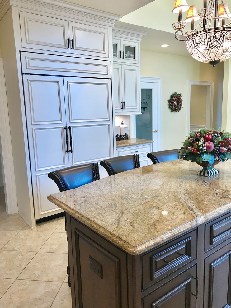 Large elegant l-shaped porcelain tile and beige floor eat-in kitchen photo in New York with a farmhouse sink, beaded inset cabinets, white cabinets, granite countertops, white backsplash, marble backsplash, stainless steel appliances and an island