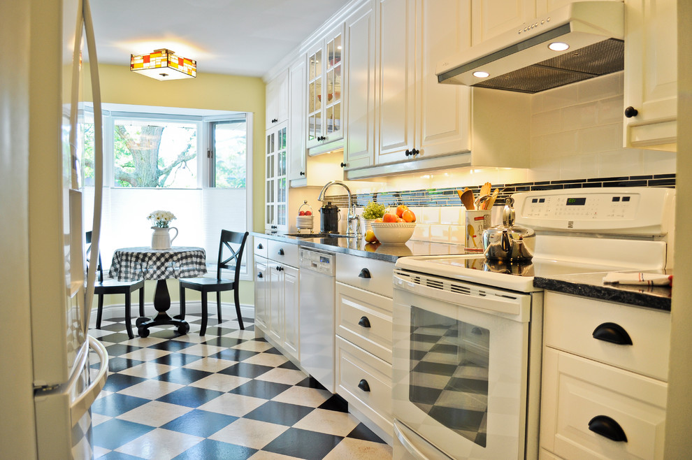 Design ideas for a classic galley kitchen in Ottawa with a single-bowl sink, raised-panel cabinets, white cabinets, black splashback, white appliances, cork flooring and no island.