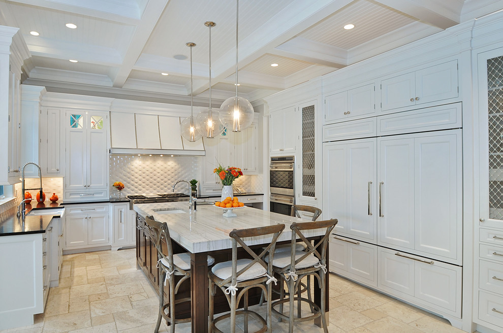 Transitional u-shaped kitchen photo in Chicago with a farmhouse sink, recessed-panel cabinets, white cabinets, white backsplash, paneled appliances and quartzite countertops