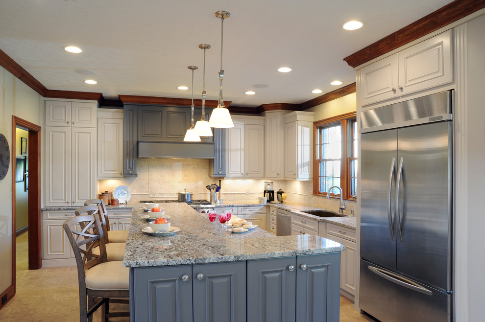 Inspiration for a mid-sized timeless u-shaped ceramic tile eat-in kitchen remodel in Cincinnati with an undermount sink, raised-panel cabinets, white cabinets, granite countertops, beige backsplash, stone tile backsplash, stainless steel appliances and an island