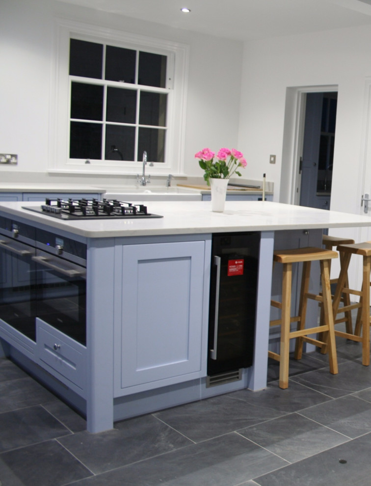 Inspiration for a large rural kitchen/diner in Berkshire with shaker cabinets, blue cabinets, slate flooring and a breakfast bar.