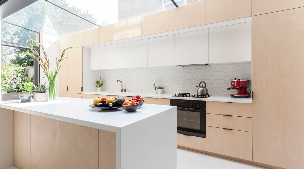 This is an example of a medium sized contemporary single-wall kitchen in London with flat-panel cabinets, light wood cabinets, quartz worktops, white splashback, an island, white floors, white worktops and integrated appliances.