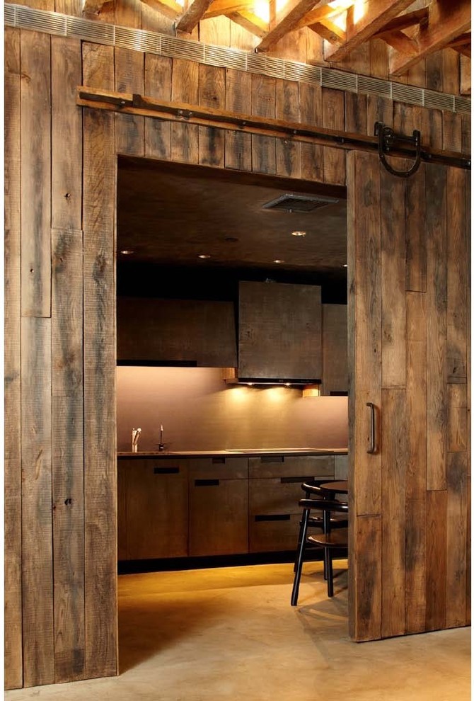 Design ideas for a large rustic kitchen/diner in New York with flat-panel cabinets, a submerged sink, composite countertops and concrete flooring.