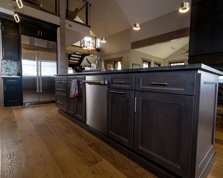 This is an example of a large contemporary l-shaped kitchen in Denver with a submerged sink, shaker cabinets, dark wood cabinets, granite worktops, multi-coloured splashback, stainless steel appliances, medium hardwood flooring, an island and brown floors.