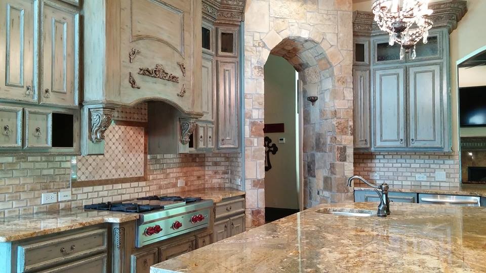 Inspiration for a large timeless u-shaped porcelain tile eat-in kitchen remodel in Houston with an undermount sink, distressed cabinets, granite countertops, beige backsplash, stainless steel appliances, an island, recessed-panel cabinets and porcelain backsplash