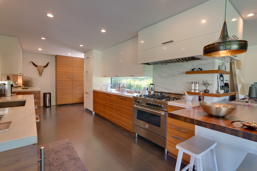 Inspiration for a large contemporary galley eat-in kitchen remodel in San Francisco with flat-panel cabinets, light wood cabinets, marble countertops, white backsplash, stainless steel appliances, an island, a single-bowl sink, marble backsplash and brown countertops