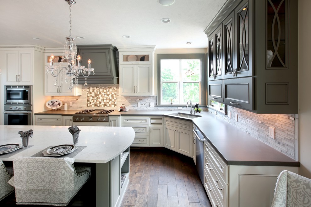 Inspiration for a large transitional l-shaped medium tone wood floor eat-in kitchen remodel in Grand Rapids with an undermount sink, concrete countertops, gray backsplash, glass tile backsplash, stainless steel appliances and an island