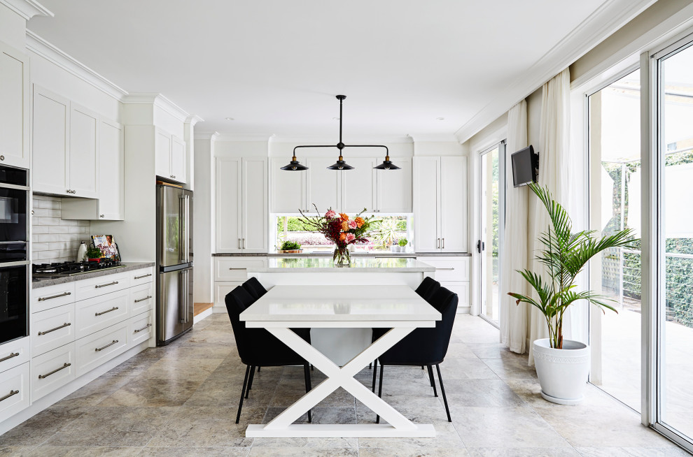 Inspiration for a large traditional l-shaped open plan kitchen in Sydney with white cabinets, engineered stone countertops, white splashback, ceramic splashback, stainless steel appliances, an island, travertine flooring, grey floors, shaker cabinets and grey worktops.