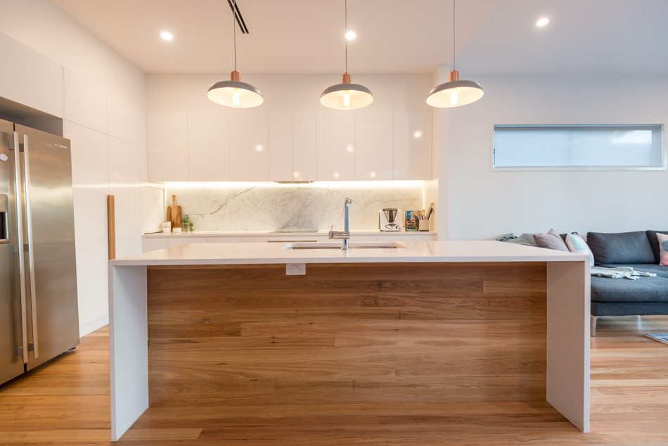 Design ideas for a scandi galley kitchen pantry in Brisbane with a submerged sink, marble worktops, grey splashback, marble splashback, stainless steel appliances, medium hardwood flooring and an island.