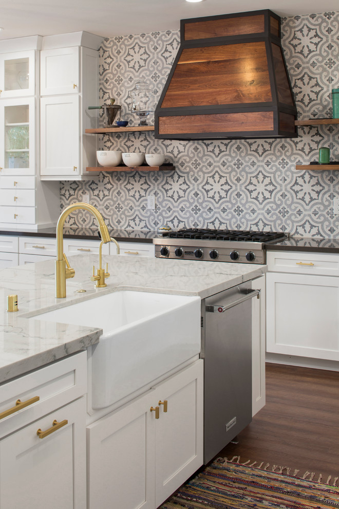 Inspiration for a medium sized classic l-shaped kitchen/diner in Sacramento with a belfast sink, shaker cabinets, white cabinets, marble worktops, grey splashback, cement tile splashback, stainless steel appliances, dark hardwood flooring, an island and brown floors.