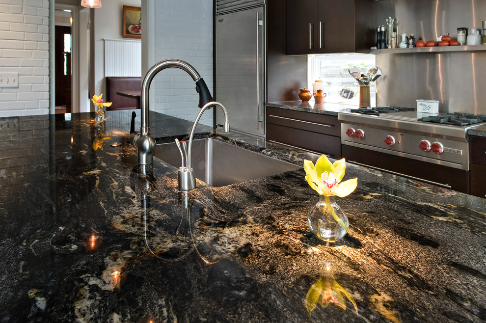 Example of a large minimalist eat-in kitchen design in DC Metro with an undermount sink, dark wood cabinets and granite countertops