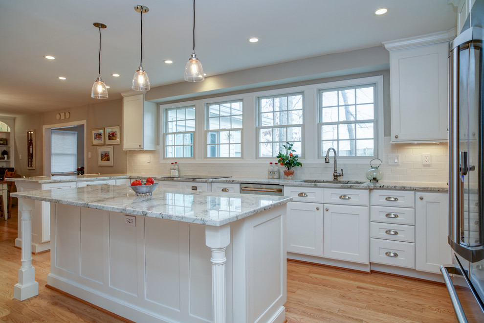 Inspiration for a mid-sized cottage u-shaped light wood floor eat-in kitchen remodel in DC Metro with a single-bowl sink, shaker cabinets, white cabinets, quartz countertops, white backsplash, subway tile backsplash, stainless steel appliances and an island