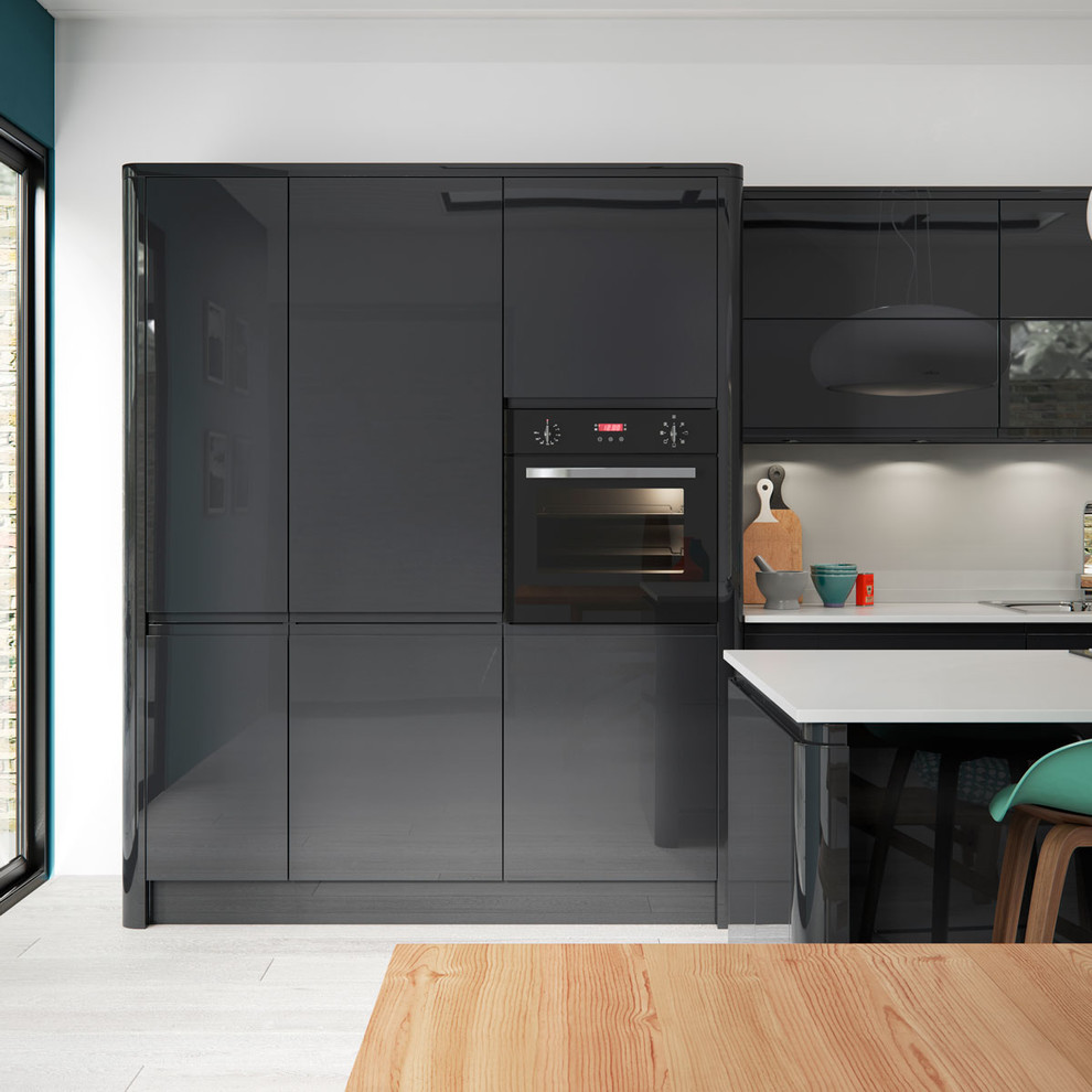 Photo of a contemporary single-wall kitchen/diner in Manchester with flat-panel cabinets, grey cabinets, quartz worktops, grey splashback, glass sheet splashback, black appliances and an island.