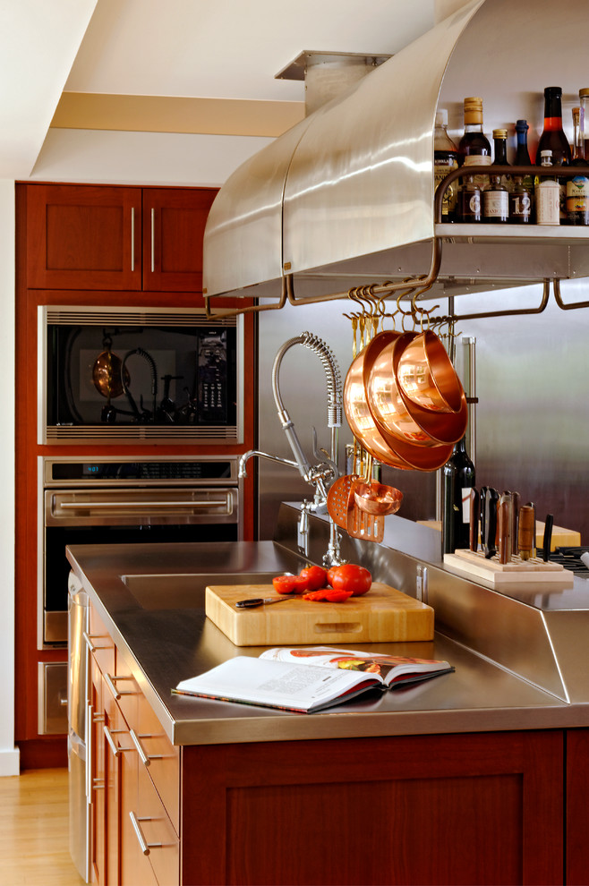 Example of an eclectic kitchen design in DC Metro with an integrated sink and stainless steel countertops