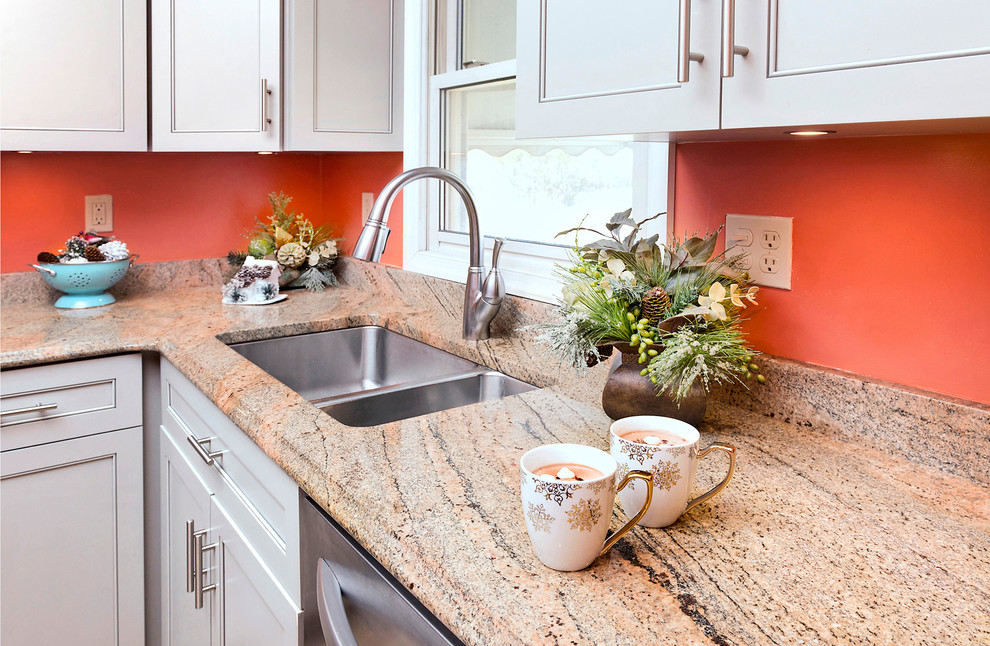 This is an example of a small classic l-shaped enclosed kitchen in Baltimore with a submerged sink, recessed-panel cabinets, white cabinets, granite worktops, stainless steel appliances, ceramic flooring, no island, orange floors and brown worktops.