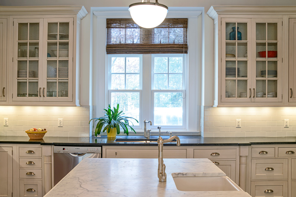 Inspiration for a timeless kitchen remodel in DC Metro with an undermount sink, shaker cabinets, white cabinets, marble countertops, subway tile backsplash, stainless steel appliances and an island