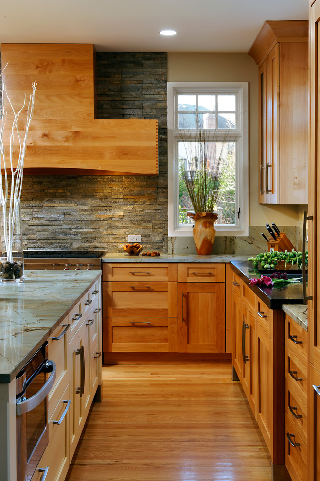Inspiration for a mid-sized transitional l-shaped light wood floor and beige floor eat-in kitchen remodel in DC Metro with shaker cabinets, light wood cabinets, granite countertops, an island, an undermount sink, gray backsplash, stone tile backsplash and stainless steel appliances