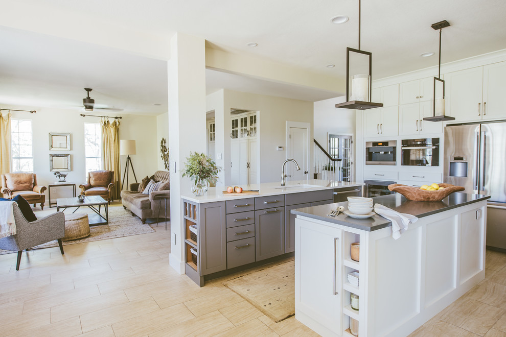 Open concept kitchen - large transitional u-shaped porcelain tile and beige floor open concept kitchen idea in Austin with shaker cabinets, white cabinets, solid surface countertops, stainless steel appliances, an undermount sink, two islands, gray backsplash and glass tile backsplash