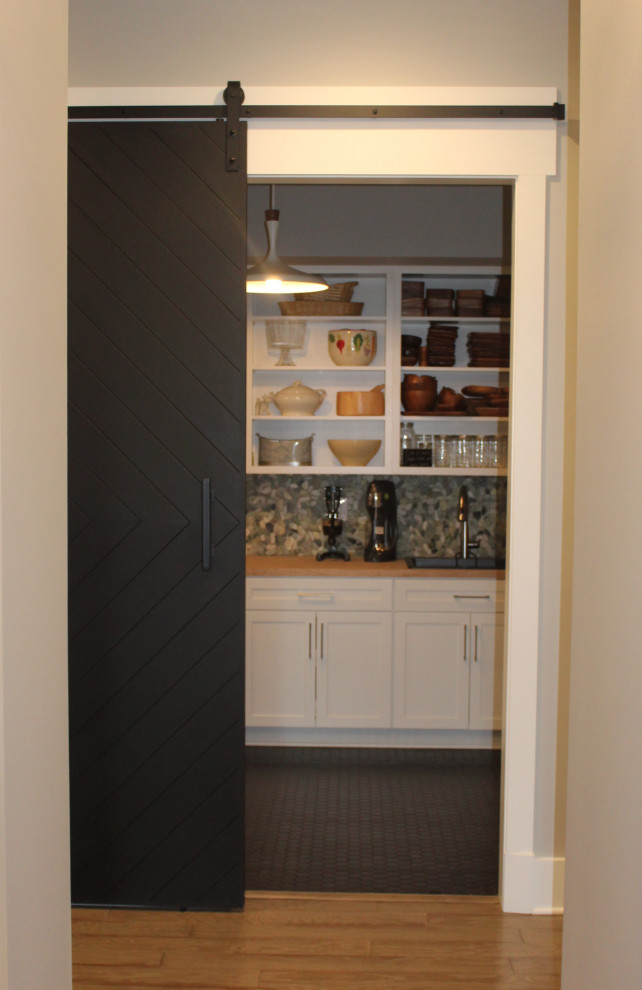 Example of a large u-shaped kitchen pantry design in DC Metro with an undermount sink, shaker cabinets, white cabinets, granite countertops, ceramic backsplash, stainless steel appliances and an island