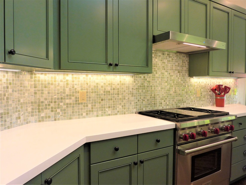 This is an example of a large classic kitchen/diner in San Francisco with a submerged sink, shaker cabinets, green cabinets, engineered stone countertops, green splashback, mosaic tiled splashback, stainless steel appliances, medium hardwood flooring, an island and white worktops.
