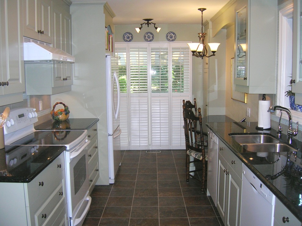 Enclosed kitchen - small transitional galley porcelain tile enclosed kitchen idea in Other with an undermount sink, raised-panel cabinets, green cabinets, granite countertops, white appliances and no island