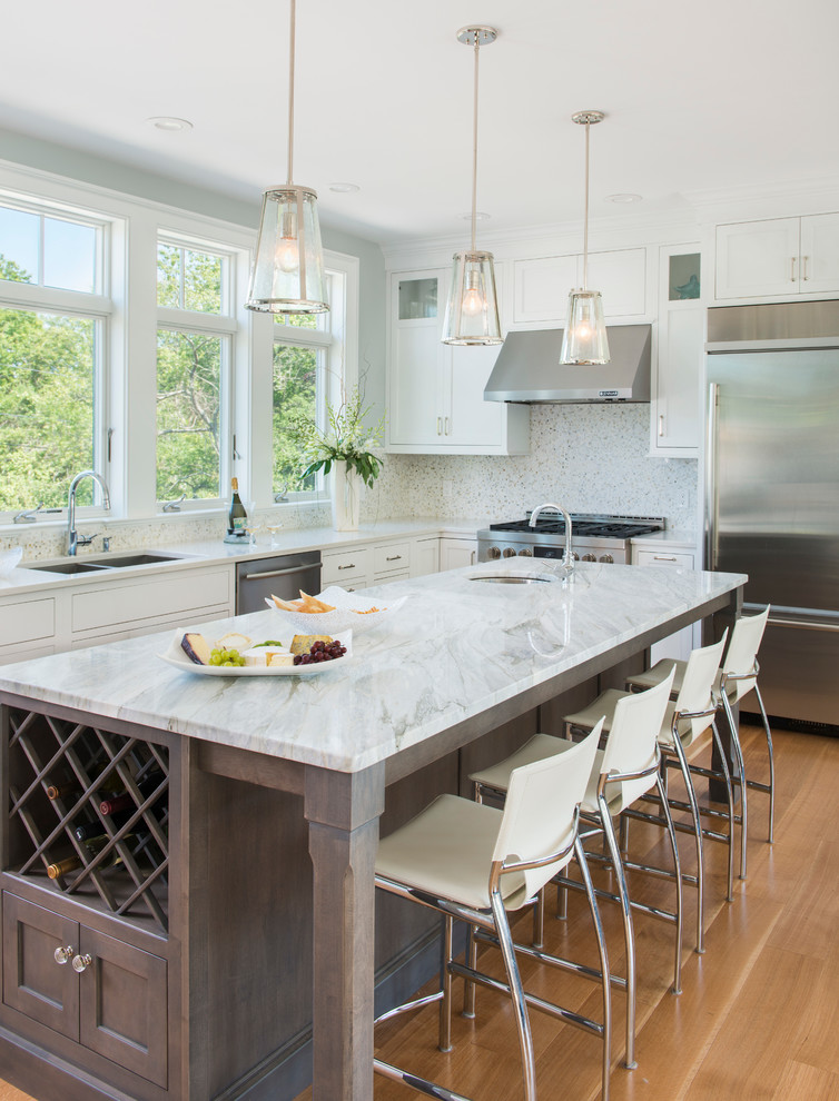 This is an example of a medium sized nautical u-shaped kitchen in Providence with a submerged sink, beaded cabinets, grey cabinets, marble worktops, white splashback, mosaic tiled splashback, stainless steel appliances, light hardwood flooring and an island.