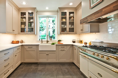 Classic kitchen with beige RTA cabinets, farmhouse sink, and glass-front uppers.