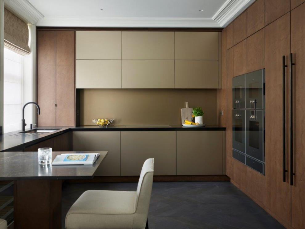 Enclosed kitchen - mid-sized contemporary l-shaped enclosed kitchen idea in Buckinghamshire with an integrated sink, flat-panel cabinets, granite countertops, metallic backsplash, glass sheet backsplash and black appliances