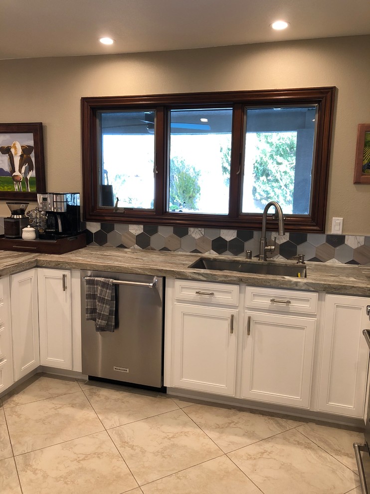 Example of a mid-sized eclectic u-shaped open concept kitchen design in Las Vegas with an undermount sink, flat-panel cabinets, white cabinets, granite countertops, multicolored backsplash, mosaic tile backsplash, stainless steel appliances and a peninsula