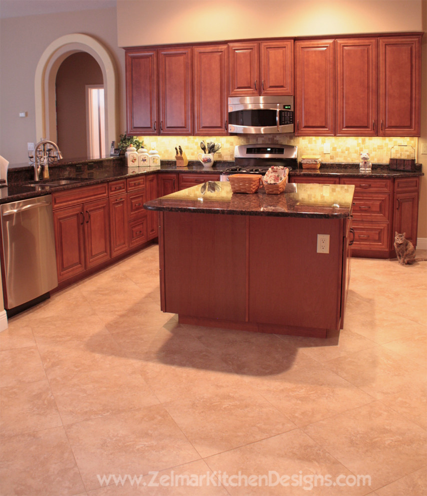 Example of a large classic u-shaped open concept kitchen design in Orlando with raised-panel cabinets, medium tone wood cabinets, granite countertops and an island