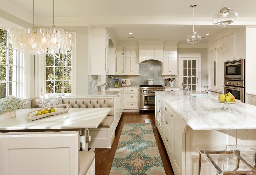Elegant l-shaped eat-in kitchen photo in DC Metro with stainless steel appliances, recessed-panel cabinets, white cabinets, quartzite countertops, blue backsplash and glass tile backsplash