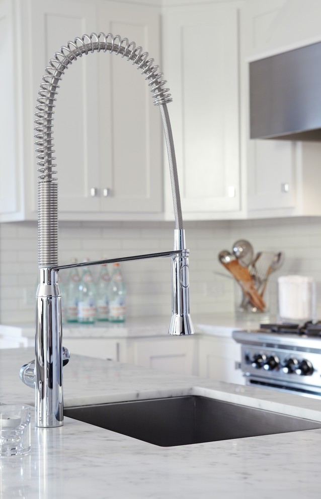 Transitional u-shaped eat-in kitchen photo in San Francisco with an undermount sink, shaker cabinets, white cabinets, marble countertops, white backsplash, subway tile backsplash, stainless steel appliances and an island